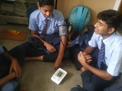 Students are checking blood pressure ann girls are observing heart beats